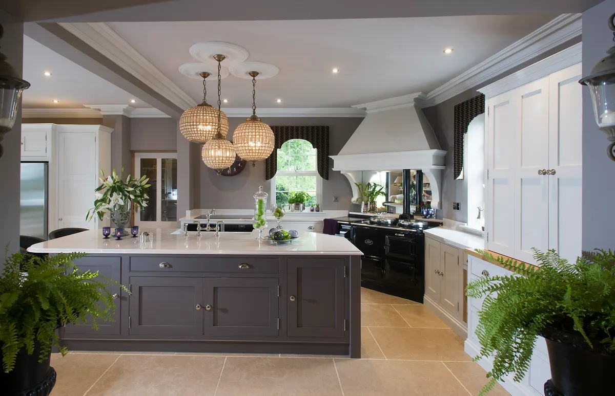 Charcoal painted kitchen with a pale island, three glass globe pendants and a black range cooker